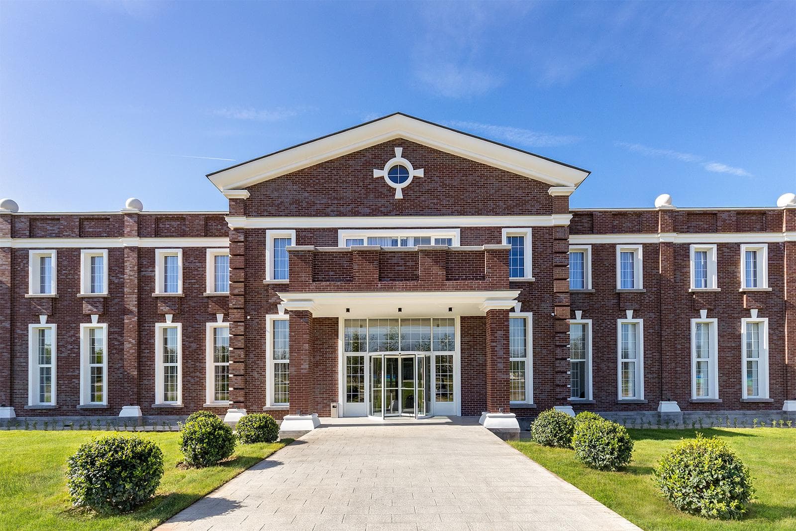 The Ambassadori Kachreti resort building under a clear sky
